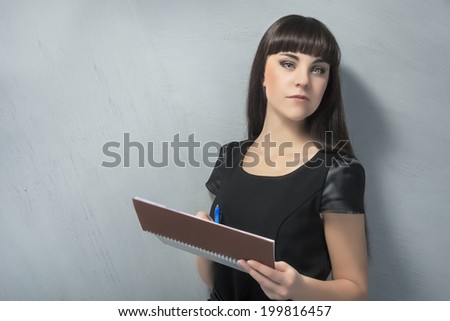Confident Young Brunette Woman With Personal Organizer. Horizontal Image