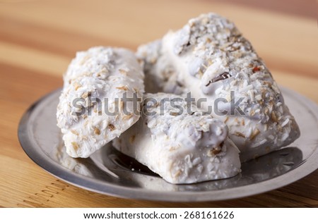 Homemade Tasty Milk Cookies with Cream Dressings and Condensed Milk Filling against of Glass of Milk on Wooden Background