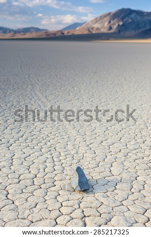 Sailing Stones at The Racetrack Playa in Death Valley National Park, California, United States. Vertical Image Composition