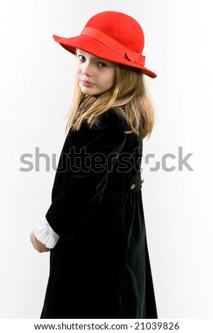 Young blonde girl standing turned right head turned back with red hat