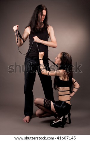 gothic couple playing role game isolated over gray background