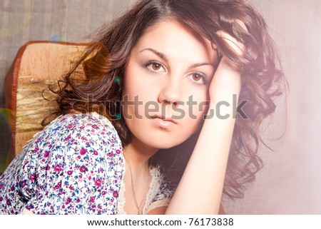 soft and gentle shoot of young caucasian brunette sitting with lifted head and looking appear. shoot with lens flare