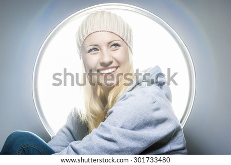 Portrait of Happy and Laughing Caucasian Blond Woman in Warm Hat and Hoody. Horizontal Image Orientation