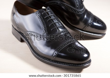 Footwear Concept. Pair of Black Fashionable Male Oxfords Semi-Brouge Laced Shoes. Horizontal Image