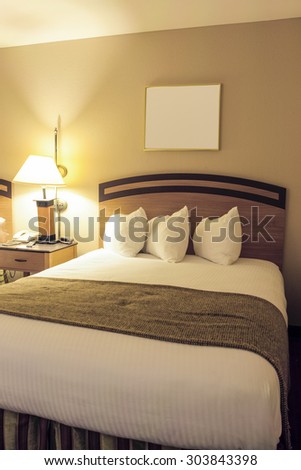 Classic Bedroom Interior with King Size Bed and Line of Arranged Pillows. Evening Time Bedroom.Vertical Composition
