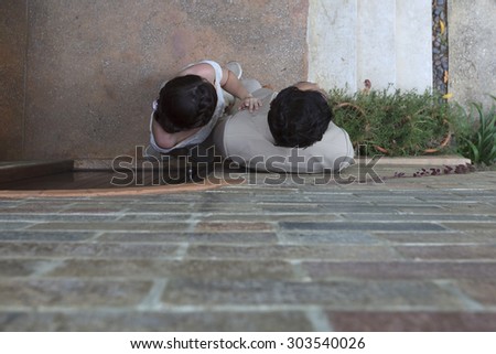 Groom and Bride Lean against wall.