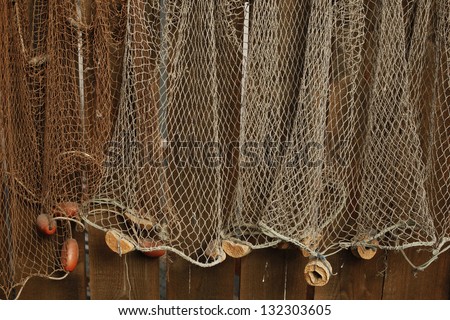 Fishing net is hanging on the wall