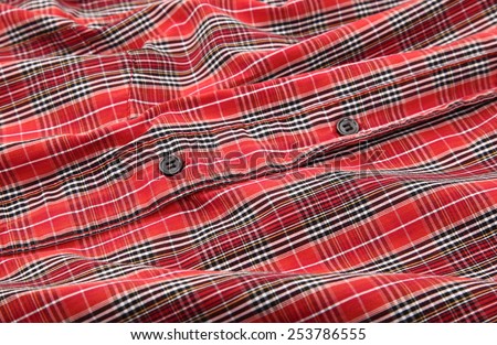 Man\'s red cotton plaid shirt detail
