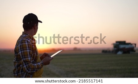 Similar – Image, Stock Photo Farmer on a tractor digs out potatoes from soil. Extract root vegetables to surface. Harvesting potatoes in autumn. Farming and farmland. Agricultural work in the field. Countryside.