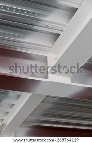 A detail of a metal decking and universal column and universal beam connected, materials are sprayed with intumescent paint