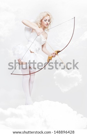 Cupid. Young beautiful blond woman in angel costume holding bow