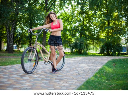 young beautiful girl with bike outdoor
