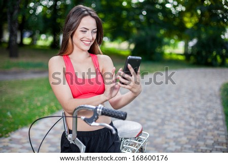 young beautiful girl with bike outdoor