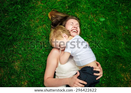 Image, Stock Photo Cheerful mom and son playing together in field