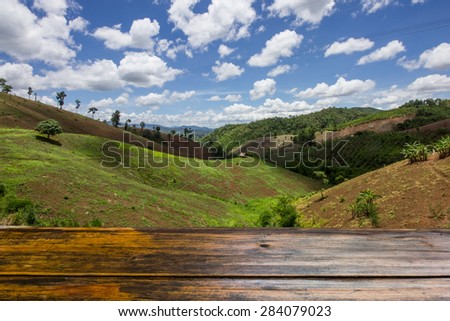 Looking out from a wooden table ,hill tribe prepared the agricultural areas,use as background.