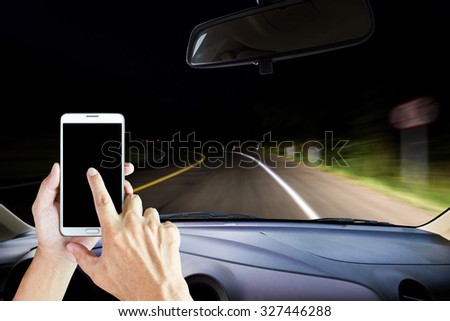 Image of windshield on the road ,way and highway, Drivers use smart phones while driving .