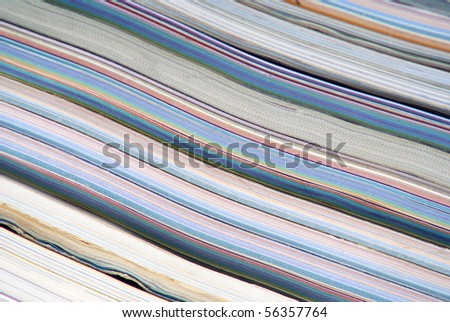 stack of colorful magazines or documents - paper edges background
