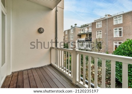 Similar – Image, Stock Photo An empty balcony and a closed shutter above it, plus a railing that no longer protects anyone