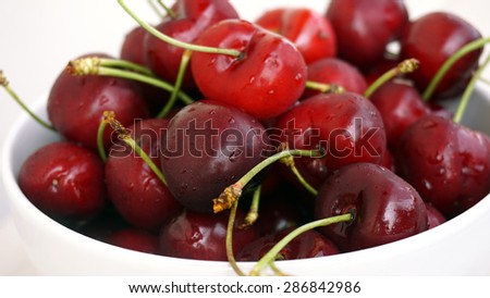 Fresh, washed, organic italian cherries from Vignola, in a white cup, macro