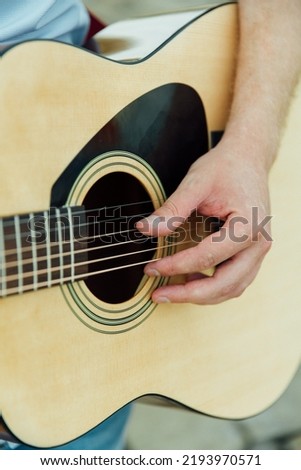 plays a yellow acoustic guitar.close-up Сток-фото © 