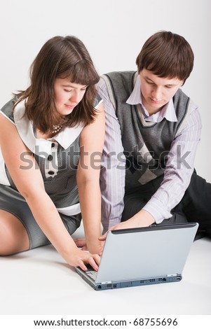 The man and the woman together work at the computer