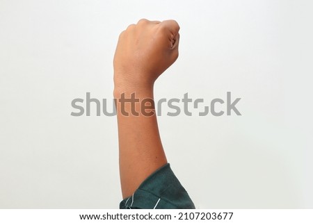 Close up of hand of young caucasian man over isolated background doing protest and revolution gesture, fist expressing force and power Foto d'archivio © 
