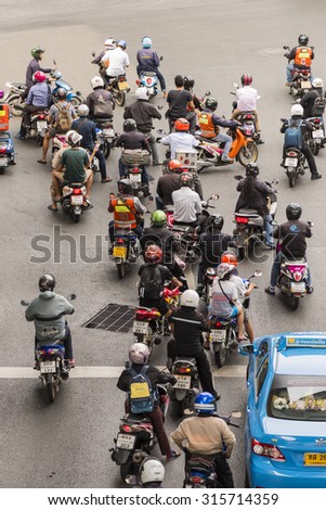 BANGKOK - JUNE 15: Motorcycles wait for a green light at a Bangkok intersection on June 15, 2015. Motorcycle sales in Thailand have increased by 13.8% since the previous year.