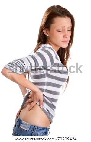 Woman with a backache bends over and rubs her lower back to relieve the pain.