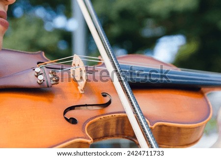 Similar – Image, Stock Photo Violin and bow in the hand of the musician in an empty room. Ban on performing in the Corona Crisis