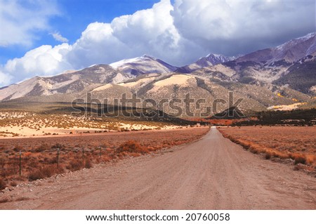 Long unpaved road to mountain