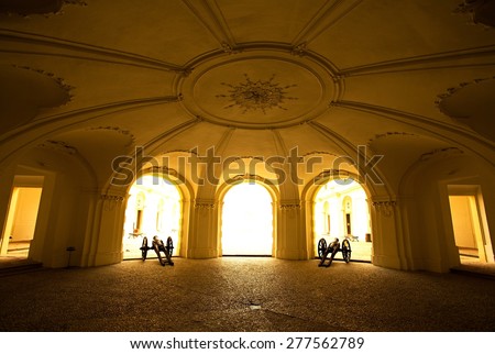 domed arcade sunlit, two guns on the sides, ornaments on the wall, widescreen