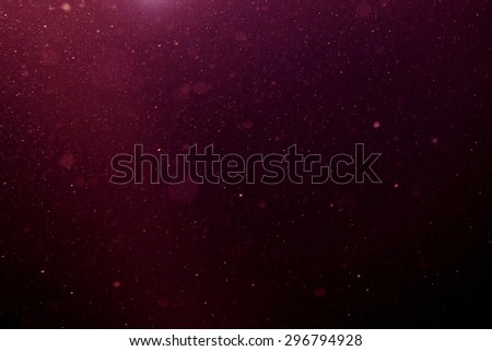 Abstract purple background with floating and reflecting dust