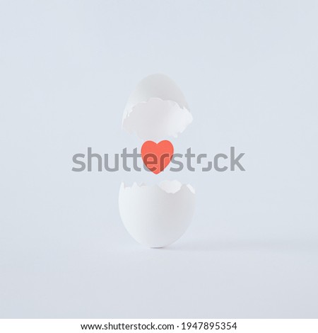 White egg in love on white background. A broken egg with a red heart in the middle. Albino mood egg. Easter inspiration. Flat lay. Bright Easter minimal concept. Organic food. Foto stock © 