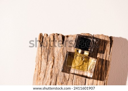 Perfume bottle mockup on old wood, on a beige background