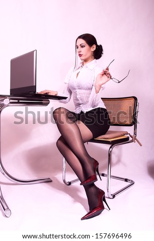 attractive secretary working on a lap top computer