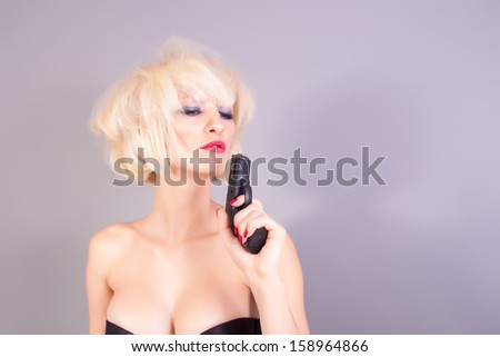 sexy blond woman holding pistol gun