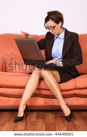 Businesswoman sitting and working on lap top computer