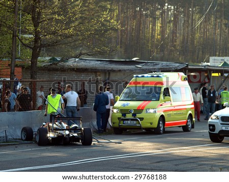 RIGA, LATIVA - MAY 2: Paramedics rush to the Formula 3 racing car Crash during Baltic Touring Car Championship at Bikernieki motorsports track May 2, 2009 in Riga, Latvia