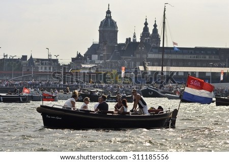 Port Amsterdam, Amsterdam, the Netherlands - August 23, 2015: Spectators in a passenger boat at the time of the SAIL (www.sail.nl), an international public nautical event held once in every 5 years.