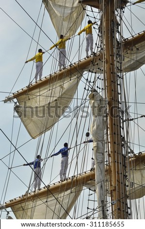 Ij river, Amsterdam, the Netherlands - August 23, 2015: Sailors of the ARC Gloria tall ship (Colombia), on the masts, on the last day of the SAIL (www.sail.nl), an international public nautical event.