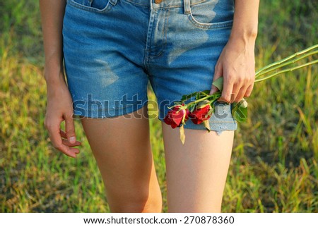 Asian young women are fall in love. She walking in the evening sunshine on the blurred meadow background.