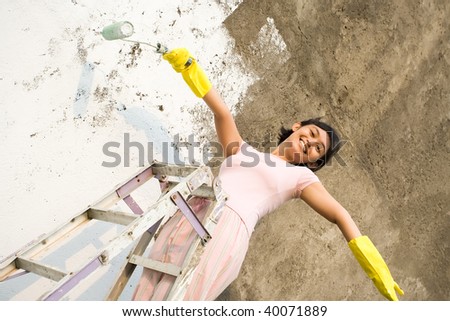 young woman happy with her painting job
