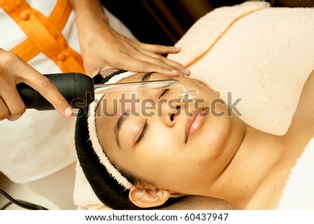 Asian young woman having facial treatment at beauty clinic