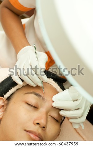 Closeup Asian young woman having facial treatment at beauty clinic