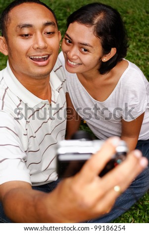 asian ethnic young couple happy taking self portrait