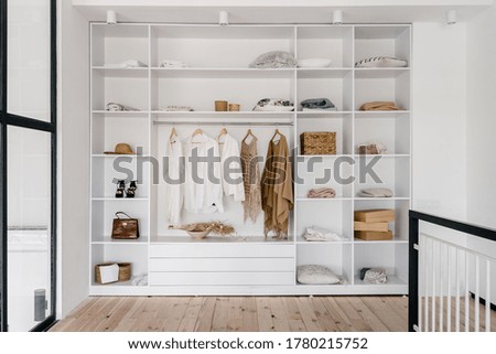 Similar – Foto Bild Blick in einen Kleiderschrank. Gemusterte Vintage Kleiderbügel und Frauenkleidung. Mode.