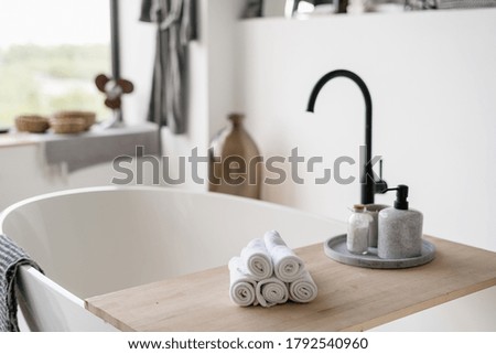 Similar – Image, Stock Photo Accessory composition detail for women and girls. White flower in a small ceramic vase with copper bracelet and golden rings and leather bag on a wooden side table at a white wall in a bright room.