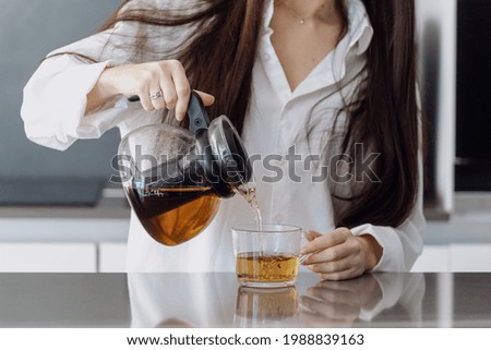 Similar – Image, Stock Photo Crop person pouring tea into bowl with herbs