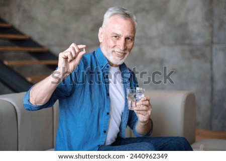 Image, Stock Photo Senior man taking prescription medicine at home