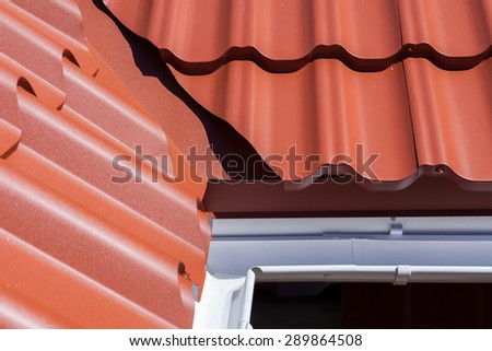 New red metal tile with white rain gutter